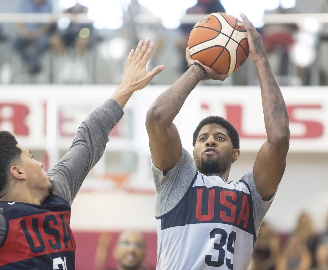 Oklahoma City Thunder forward Paul George (39) shoots over Phoenix Suns guard Devin Booker (31) during Team USA basketball's minicamp on Friday, July 27, 2018, at the Mendenhall Center, in Las Veg ...