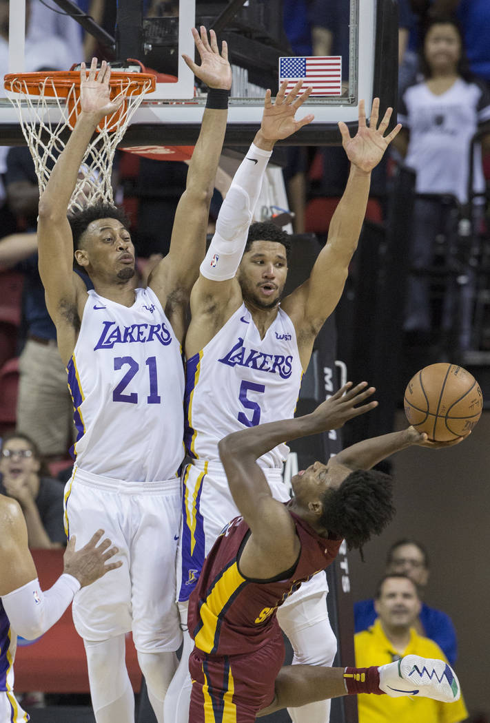 Los Angeles Lakers defenders Jonathan Williams (21) and Josh Hart (5) defend Cleveland Cavaliers guard Collin Sexton (2) in the fourth quarter during the NBA Summer League semifinals on Monday, Ju ...