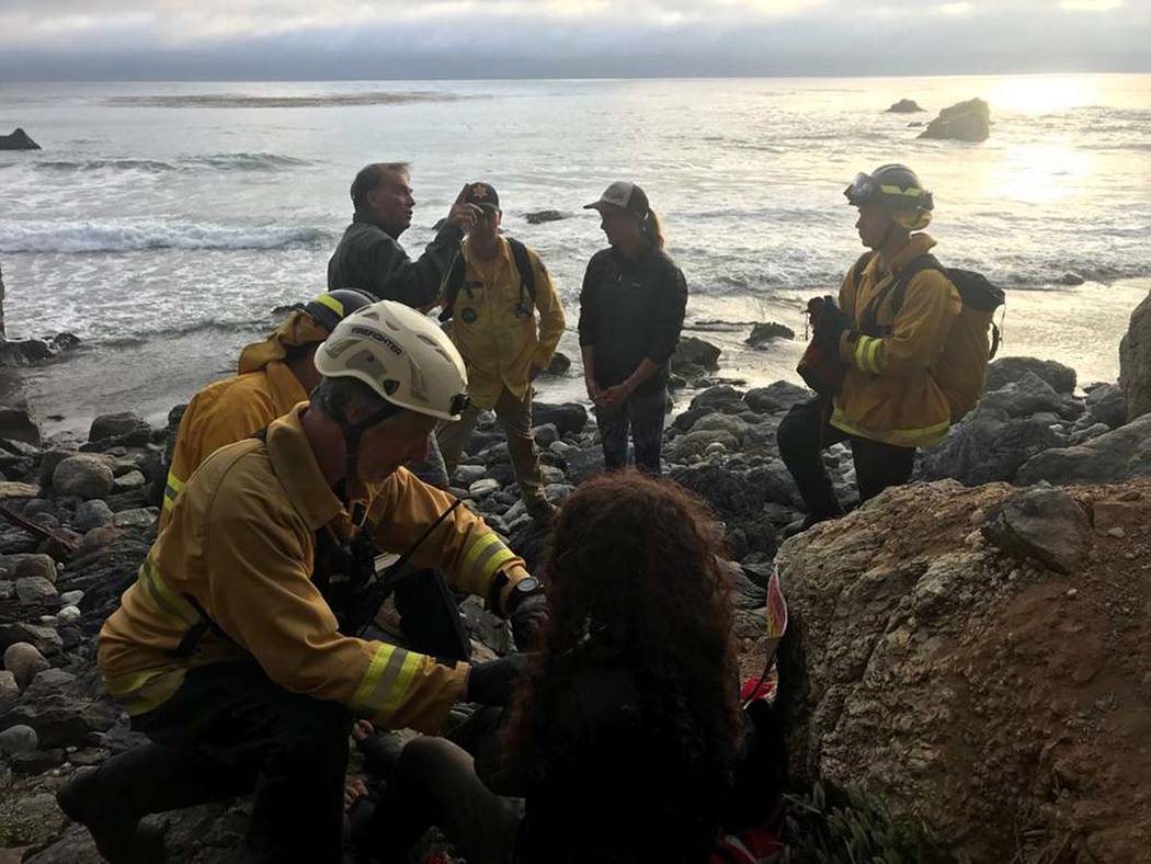 In this Friday, July 13, 2018, photo posted on the Monterey County, Calif., Sheriff's Office Twitter feed, authorities tend to Angela Hernandez, foreground center, after she was rescued, in Morro ...