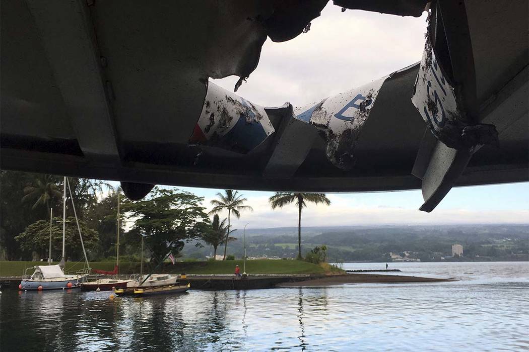 This photo provided by the Hawaii Department of Land and Natural Resources shows damage to the roof of a tour boat after an explosion sent lava flying through the roof off the Big Island of Hawaii ...