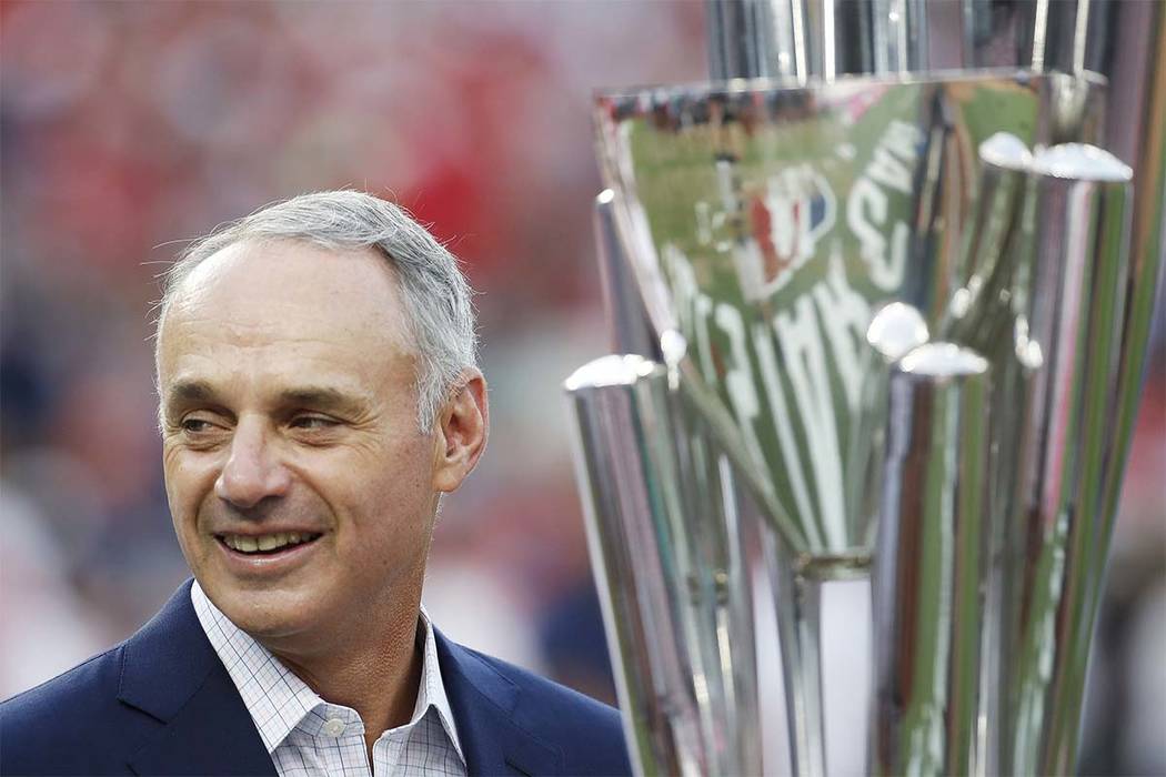 Major League Baseball Commissioner Rob Manfred stands with trophy before the MLB Home Run Derby, at Nationals Park, Monday, July 16, 2018 in Washington. The 89th MLB baseball All-Star Game will be ...