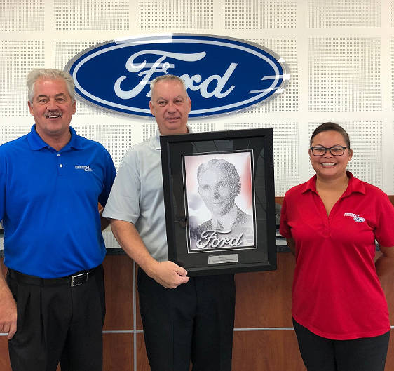 Longtime Friendly Ford service adviser Paul Deems, center, is congratulated by service director Greg Haas and assistant service manager Michelle Ochoa for being named the 2017 Employee Excellence ...