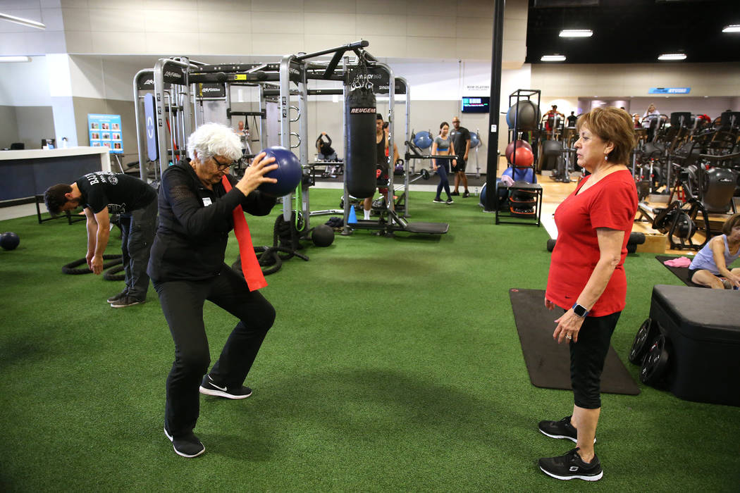 Fitness coach Olga Connolly, left, 85, works with Priscilla Whitt at the EoS Fitness gym, 7070 S Durango Drive, in Las Vegas, Wednesday, July 18, 2018. Connolly is a former Olympian who won a gold ...