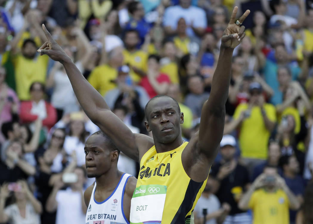 Britain's James Dasaolu, left, stands beside Jamaica's Usain Bolt before a men's 100-meter heat at the Olympic stadium in Rio de Janeiro, Brazil, Saturday, Aug. 13, 2016. (Matt Dunham/The Associat ...