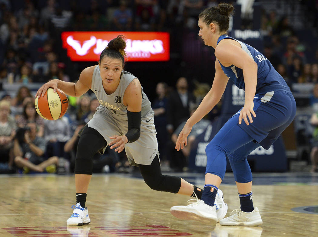 Las Vegas Aces guard Kayla McBride drives against Minnesota Lynx forward Cecilia Zandalasini (9) during the second half of a WNBA basketball game Friday, July 13, 2018, in Minneapolis. (Aaron Lavi ...