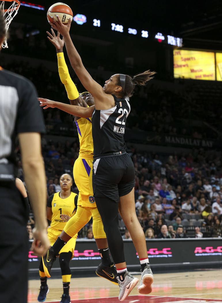 Las Vegas Aces center A'ja Wilson (22) goes up for a shot against Los Angeles Sparks forward Essence Carson (17) during the first half of a WNBA basketball game at the Mandalay Bay Events Center i ...