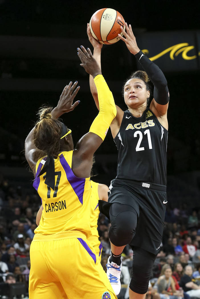 Las Vegas Aces guard Kayla McBride (21) shoots over Los Angeles Sparks forward Essence Carson (17) during the second half of a WNBA basketball game at the Mandalay Bay Events Center in Las Vegas o ...
