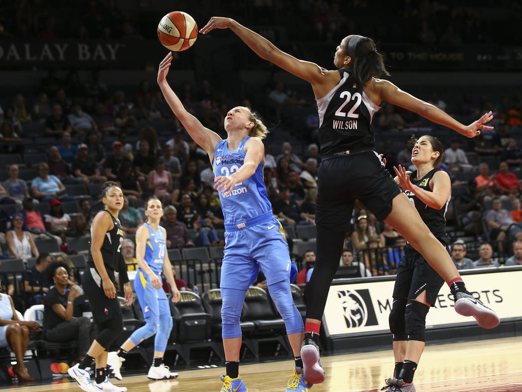 Las Vegas Aces center A'ja Wilson (22) blocks a shot rom Chicago Sky guard Courtney Vandersloot (22) during the first half of a WNBA basketball game at Mandalay Bay Events Center in Las Vegas on T ...