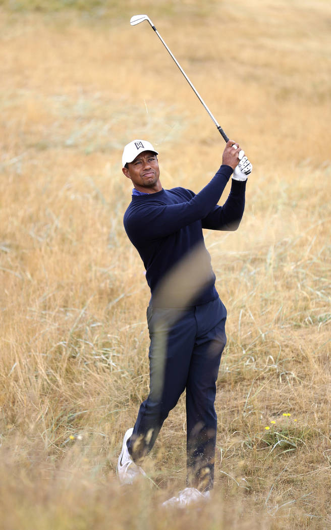 Tiger Woods of the U.S. plays out of the rough on the 2nd hole during a practice round for the 147th British Open Golf championships in Carnoustie, Scotland, Tuesday, July 17, 2018. (AP Photo/Pete ...