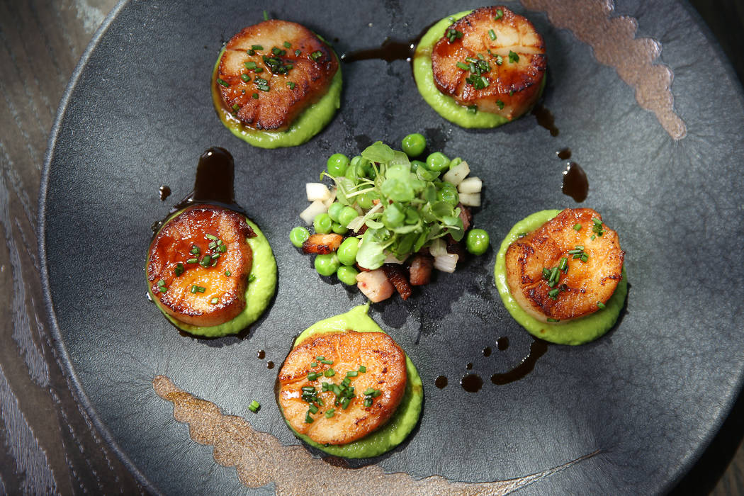Pan seared scallops served with english pea puree, braised bacon lardons and pickled fennel, at Gordon Ramsay Hell's Kitchen in Las Vegas, Tuesday, July 17, 2018. Erik Verduzco Las Vegas Review-Jo ...