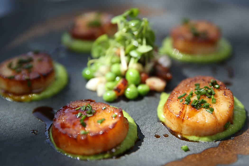 Pan seared scallops served with english pea puree, braised bacon lardons and pickled fennel, at Gordon Ramsay Hell's Kitchen in Las Vegas, Tuesday, July 17, 2018. Erik Verduzco Las Vegas Review-Jo ...