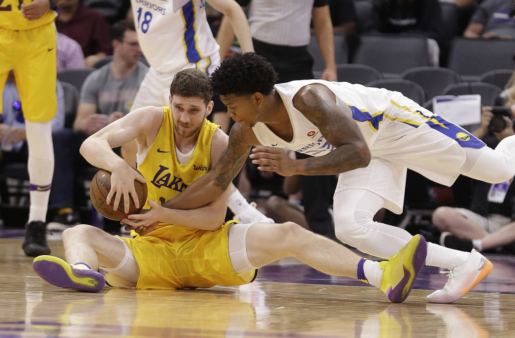 Los Angeles Lakers forward Sviatoslav Mykhailiuk, left, and Golden State Warriors guard Rion Brown battle for the ball during the first half of an NBA summer league basketball game Thursday, July ...