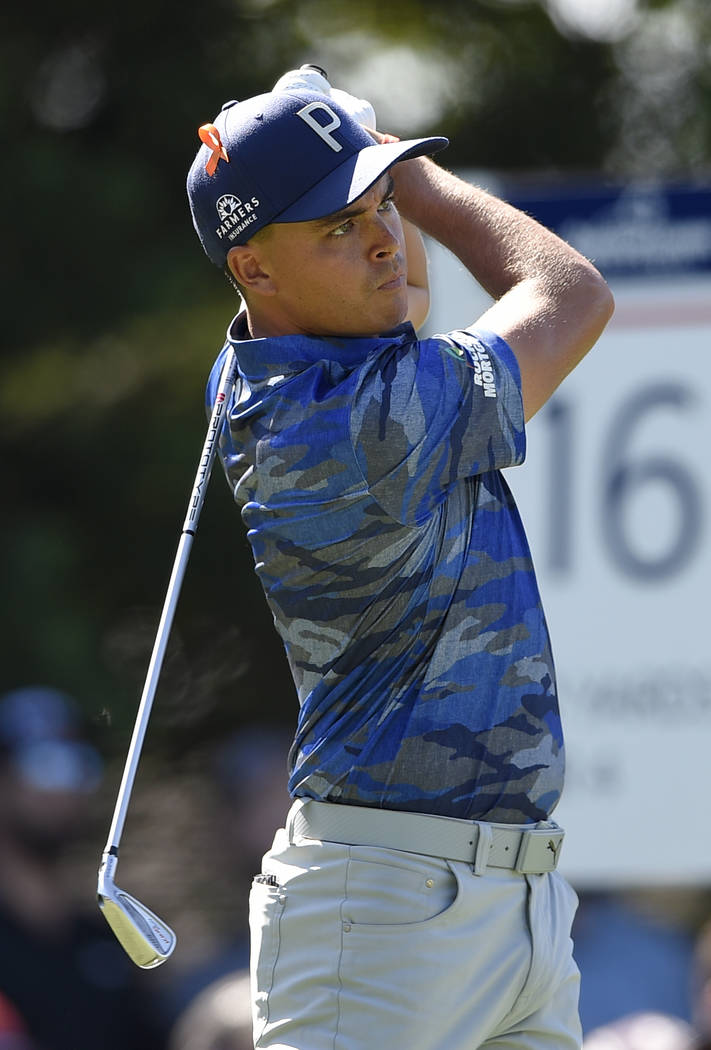 Rickie Fowler watches his tee shot on the 16th tee during the second round of the Quicken Loans National golf tournament, Friday, June 29, 2018, in Potomac, Md. (AP Photo/Nick Wass)