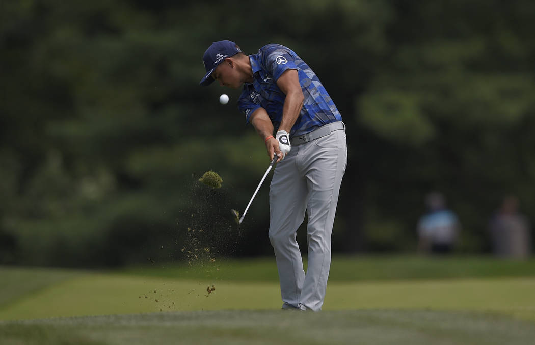 Rickie Fowler hits on the seventh hole during the second round of the Quicken Loans National golf tournament, Friday, June 29, 2018, in Potomac, Md. (AP Photo/Nick Wass)