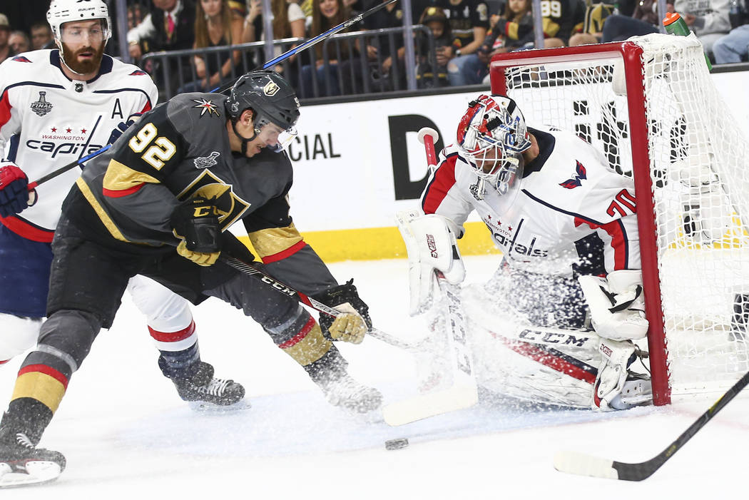 Golden Knights left wing Tomas Nosek (92) tries to get the puck in against Washington Capitals goaltender Braden Holtby (70) during the first period of Game 5 of the Stanley Cup Final at T-Mobile ...