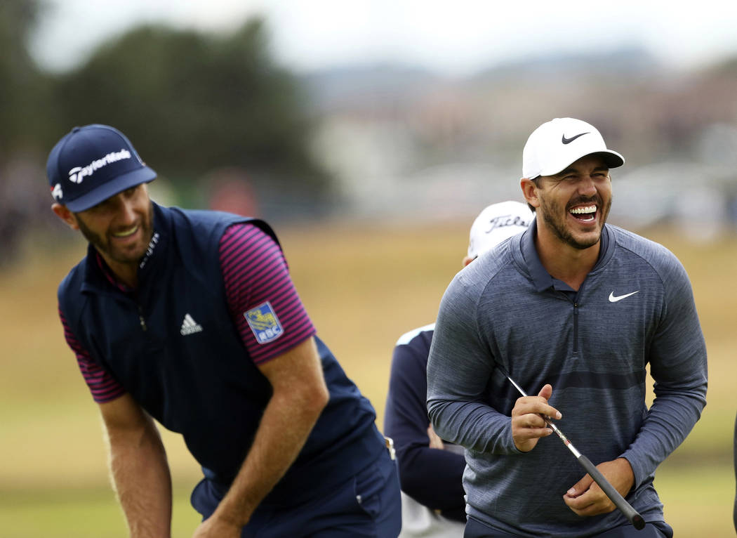 U.S. golfer's Dustin Johnson, left and Brooks Koepka share a joke while putting on the 16th green during a practice round for the 147th Open golf Championship at Carnoustie golf club, Scotland, Mo ...