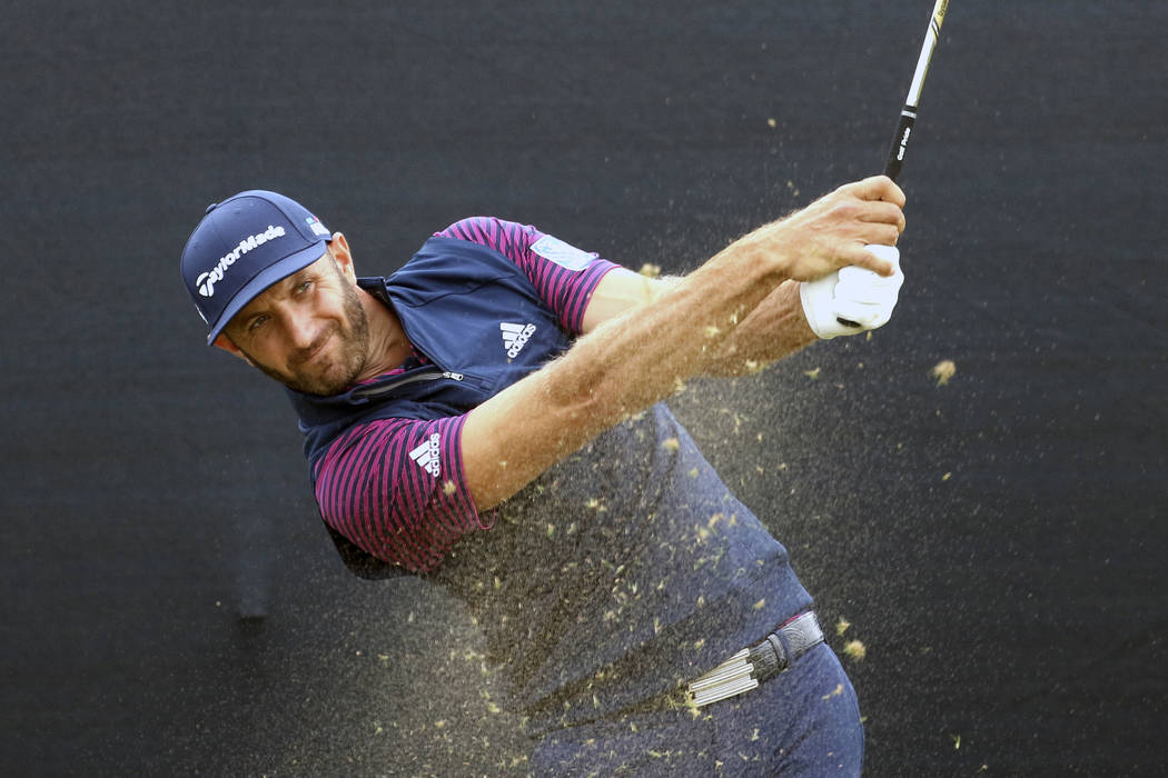 U.S. golfer Dustin Johnson tees off on the 16th par 3 during a practice round for the 147th Open golf Championship at Carnoustie golf club, Scotland, Monday July 16, 2018. (AP Photo/Peter Morrison)