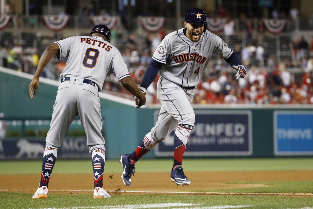 Houston Astros outfielder George Springer (4) celebrates his solo home run in the tenth inning during the Major League Baseball All-star Game, Tuesday, July 17, 2018 in Washington. (AP Photo/Patri ...