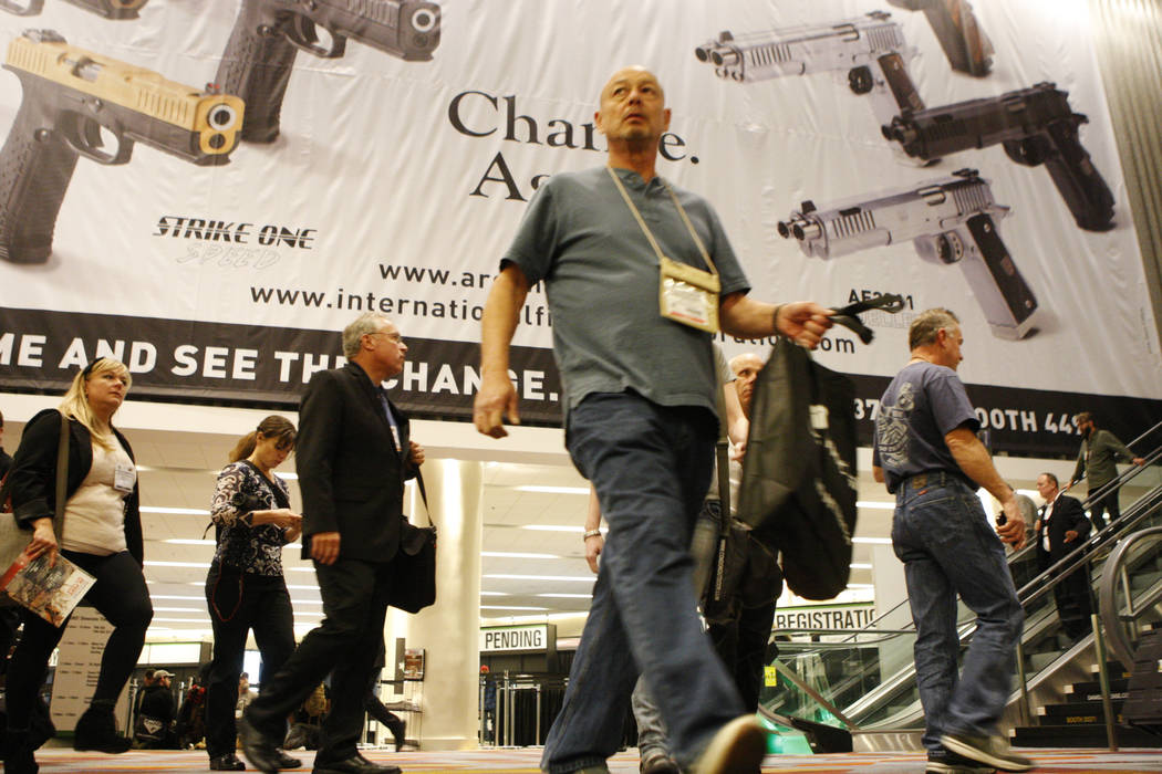People walk in the Sands Expo Convention Center during the annual Shooting, Hunting and Outdoors Trade Show Tuesday, Jan. 20, 2015. (Erik Verduzco/Las Vegas Review-Journal)