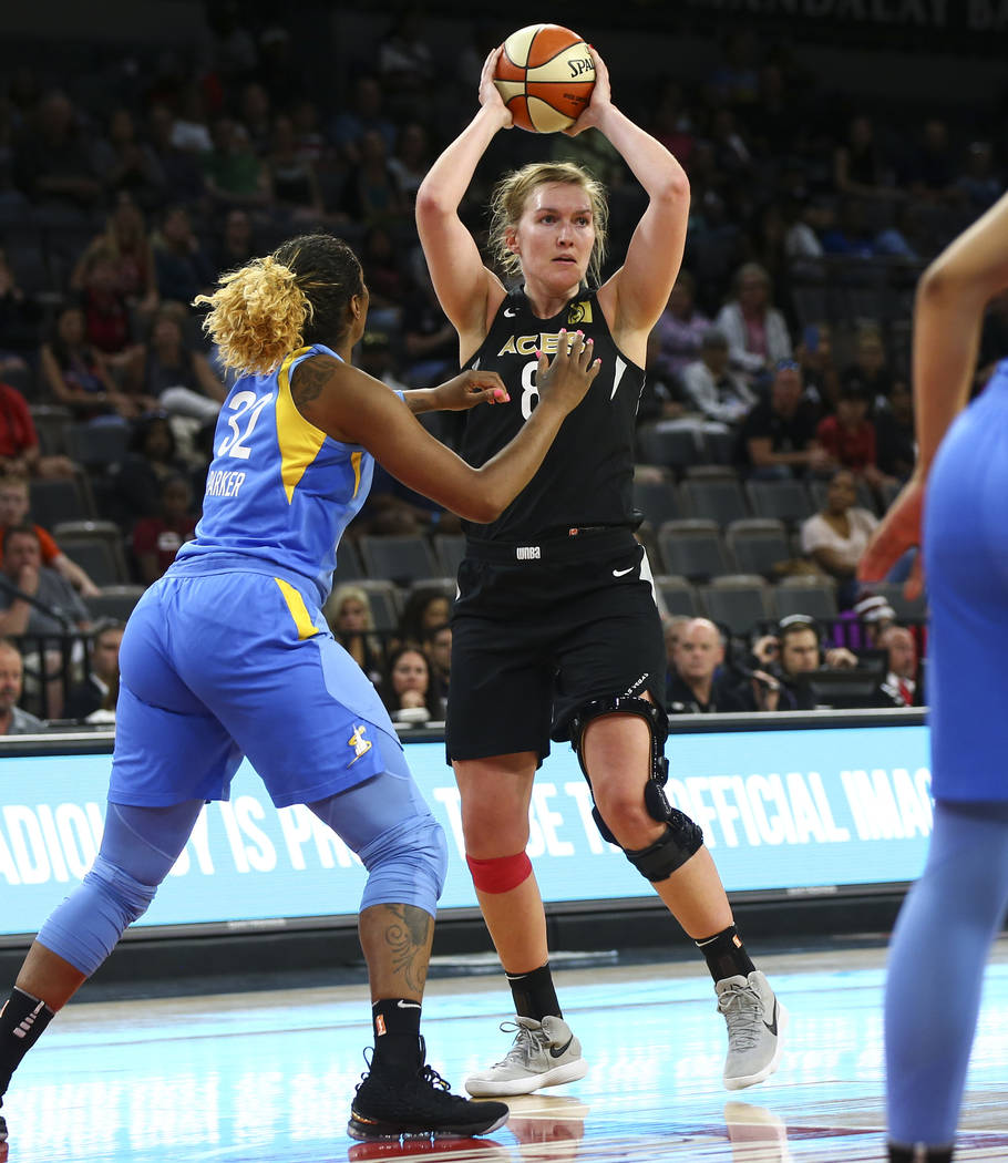 Las Vegas Aces center Carolyn Swords (8) looks to pass the ball in front of Chicago Sky forward Cheyenne Parker (32) during the second half of a WNBA basketball game at Mandalay Bay Events Center ...