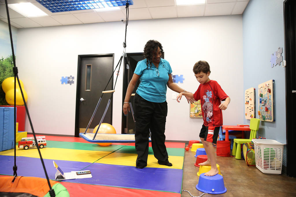 Samuel Mateo, 8, works with registered behavior technicia Doris Lofton during his session at the Touro University Nevada Center for Autism and Developmental Disabilities in Henderson, Tuesday, Jul ...