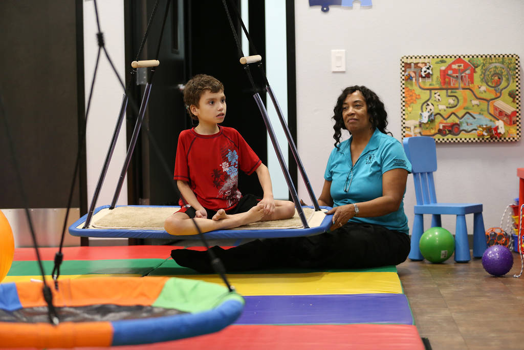 Samuel Mateo, 8, works with registered behavior technicia Doris Lofton during his session at the Touro University Nevada Center for Autism and Developmental Disabilities in Henderson, Tuesday, Jul ...
