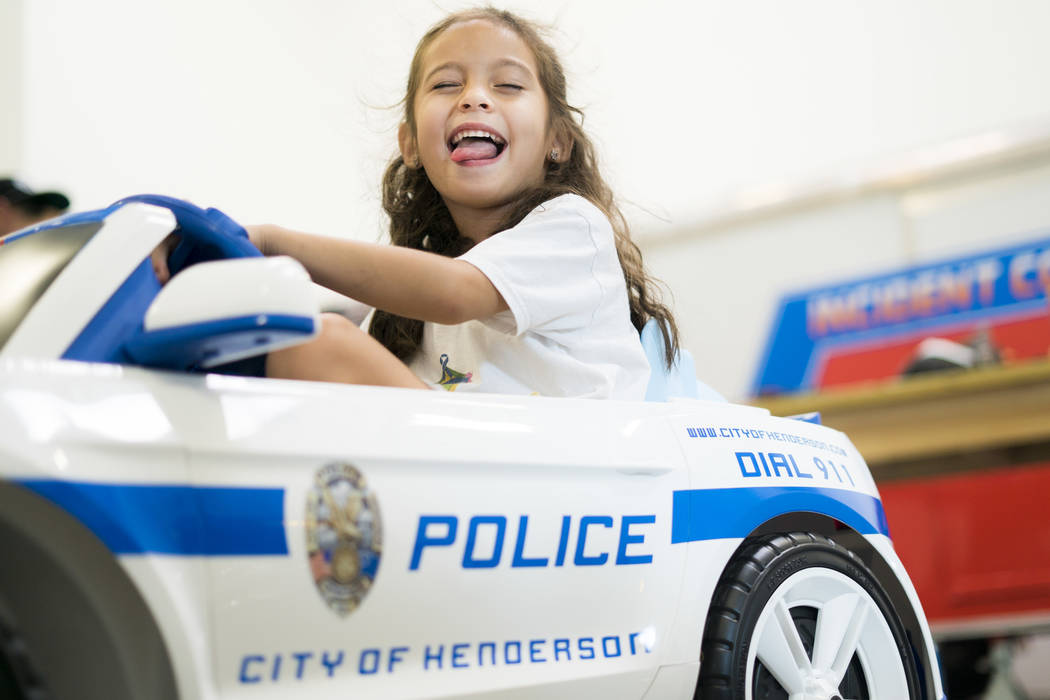 Theresa Babcock, 5, drives her city of Henderson police car in Henderson, Monday, July 9, 2018. (Marcus Villagran/Las Vegas Review-Journal) @brokejournalist