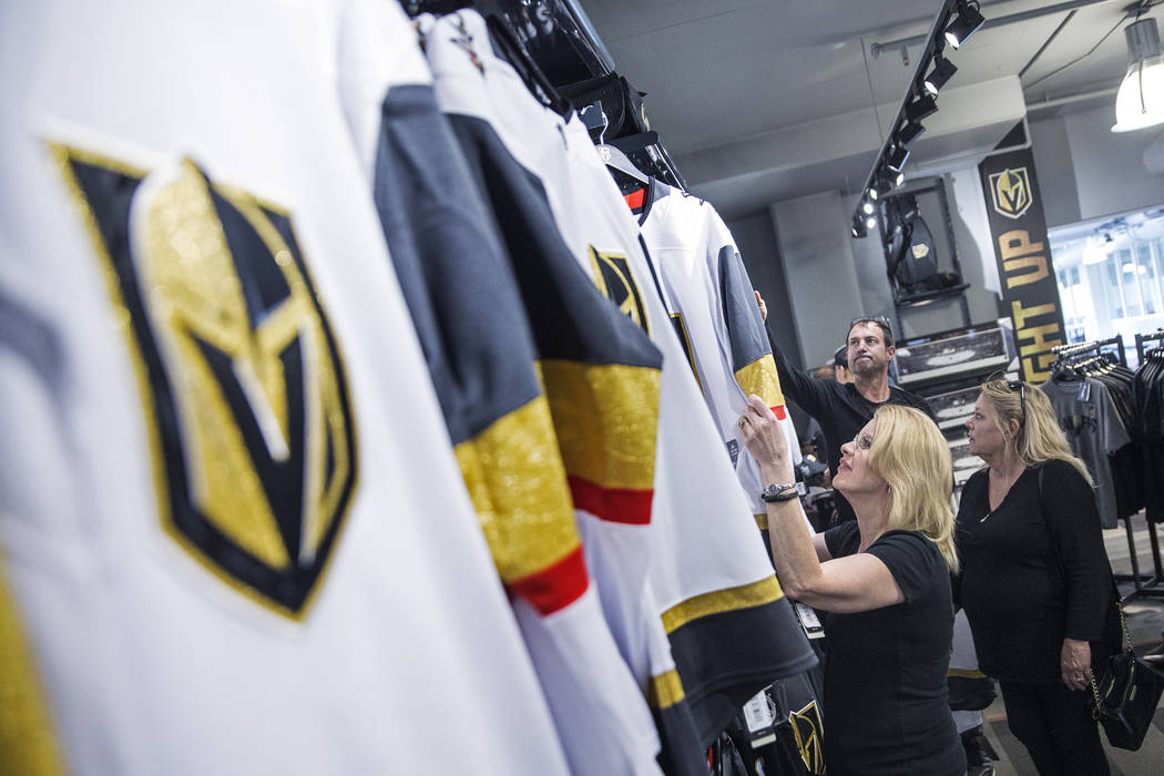 Charmaine Pennington, left, shops for Golden Knights jerseys on Wednesday, April 18, 2018, at The Arsenal, in Las Vegas. "We're buying one for our son who's in the Air Force in North Carolina ...