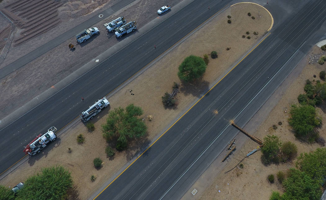 Aerial view of crews repairing fallen power lines on Boulder Highway that were brought down by a late-night thunderstorm on Boulder Highway between Russell and Sunset road, Friday, July 20, 2018. ...