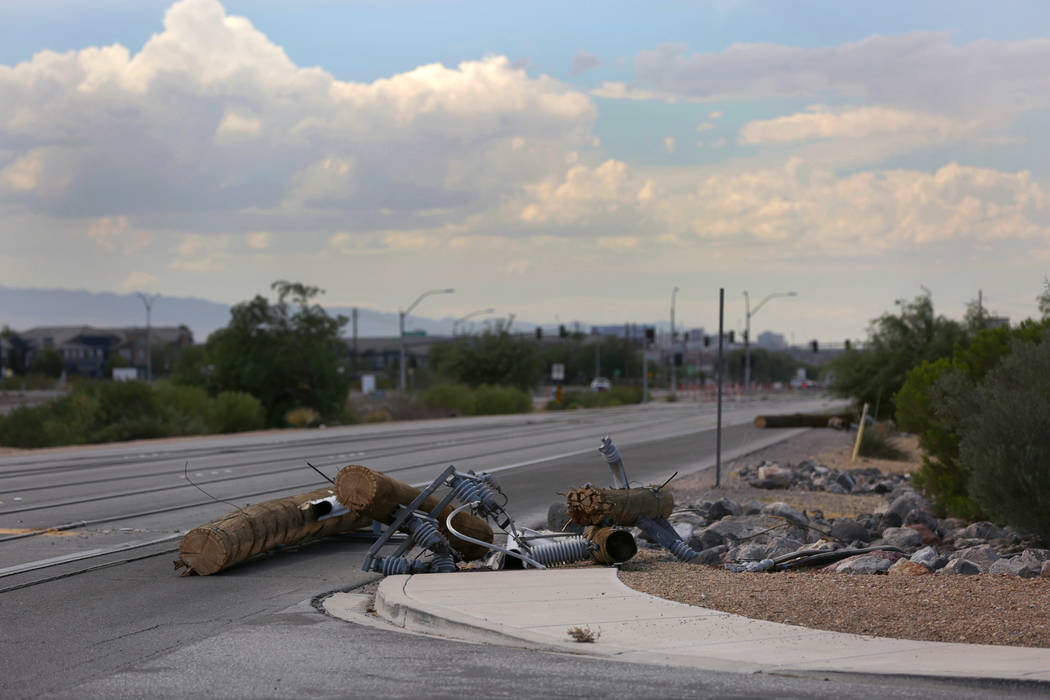 Power lines damaged by a late-night thunderstorm on Boulder Highway lie scattered in pieces on the ground between Russell and Sunset road, Friday, July 20, 2018. Michael Quine/Las Vegas Review-Jou ...