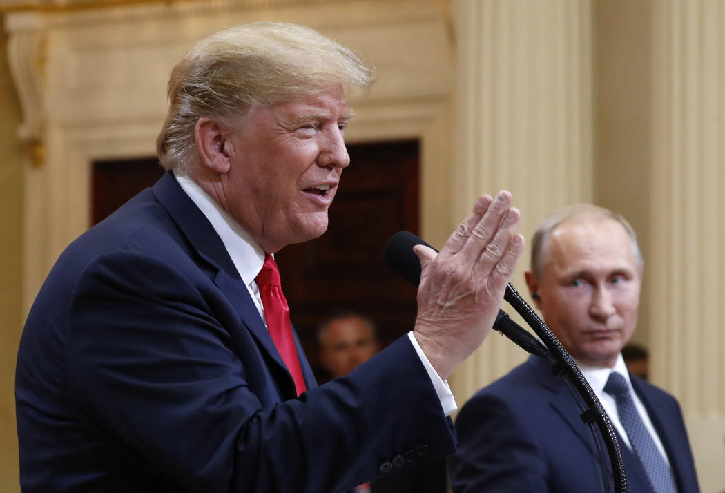President Donald Trump speaks with Russian President Vladimir Putin during a press conference after their meeting at the Presidential Palace in Helsinki, Finland, Monday, July 16, 2018. (Pablo Mar ...