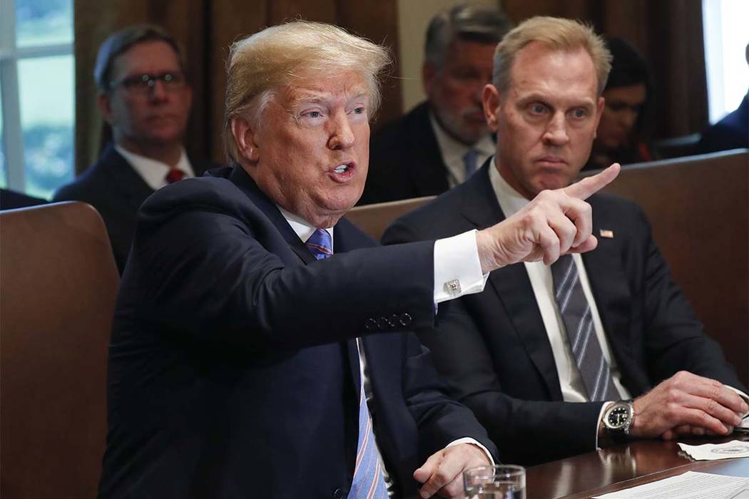 President Donald Trump gestures while speaking during his meeting with members of his cabinet in Cabinet Room of the White House in Washington, Wednesday, July 18, 2018. Looking on is Deputy Secre ...