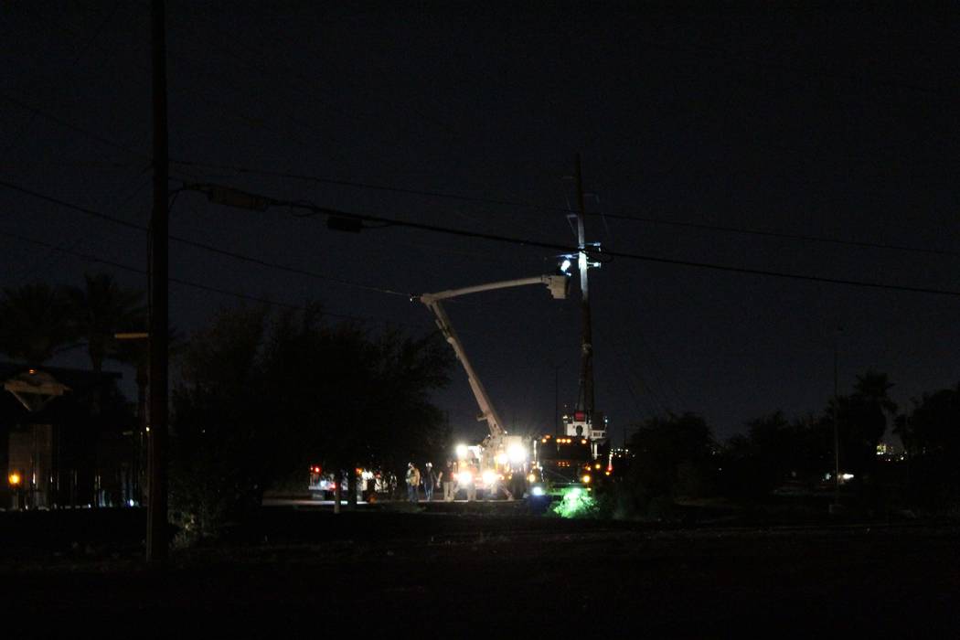 Crews from NV Energy work to repair power lines damaged by a late-night thunderstorm on Boulder Highway near Sunset Road. (Max Michor/Las Vegas Review-Journal)