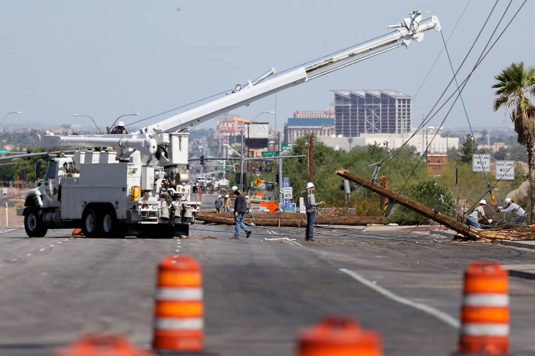 Crews from NV Energy repair power lines damaged by a late-night thunderstorm on Boulder Highway between Russell and Sunset road, Friday, July 20, 2018. (K.M. Cannon/Las Vegas Review-Journal)