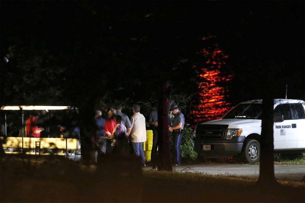 Rescue crews work at the scene of a deadly boat accident at Table Rock Lake in Branson, Mo., Thursday, July 19, 2018. A sheriff in Missouri said a tourist boat has apparently capsized on the lake, ...