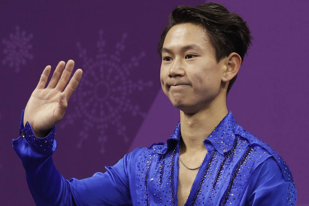 Figure skater Denis Ten, of Kazakhstan, reacts as his score is posted following his performance in the men's short program figure skating, in the Gangneung Ice Arena at the 2018 Winter Olympics in ...