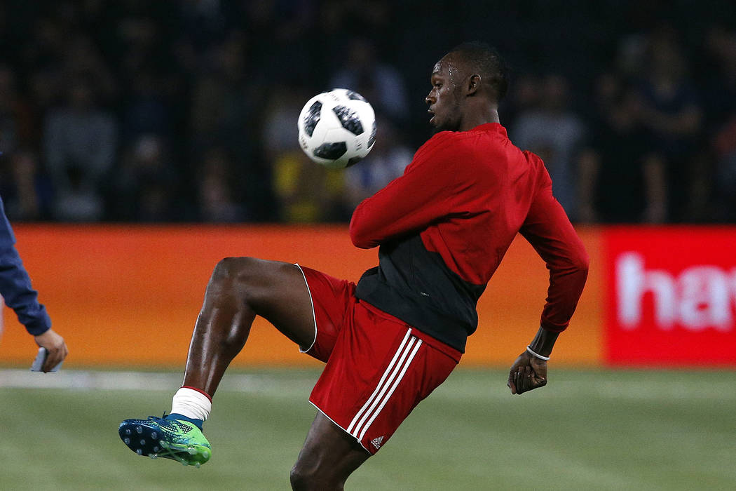 Former Olympic and Jamaican sprinter Usain Bolt controls the ball during a training session prior to the charity soccer match between members of the 1998 World Cup winning French team and a team o ...