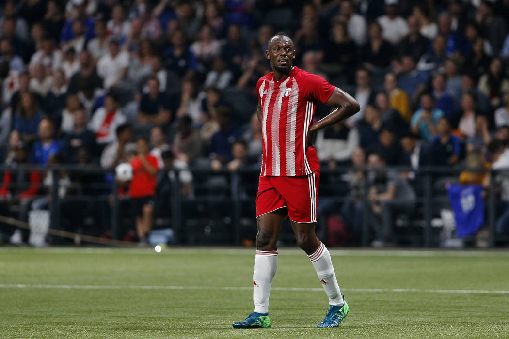 Former Olympic and Jamaican sprinter Usain Bolt reacts during a charity soccer match between members of the 1998 World Cup winning French team and a team of international veteran players who were ...