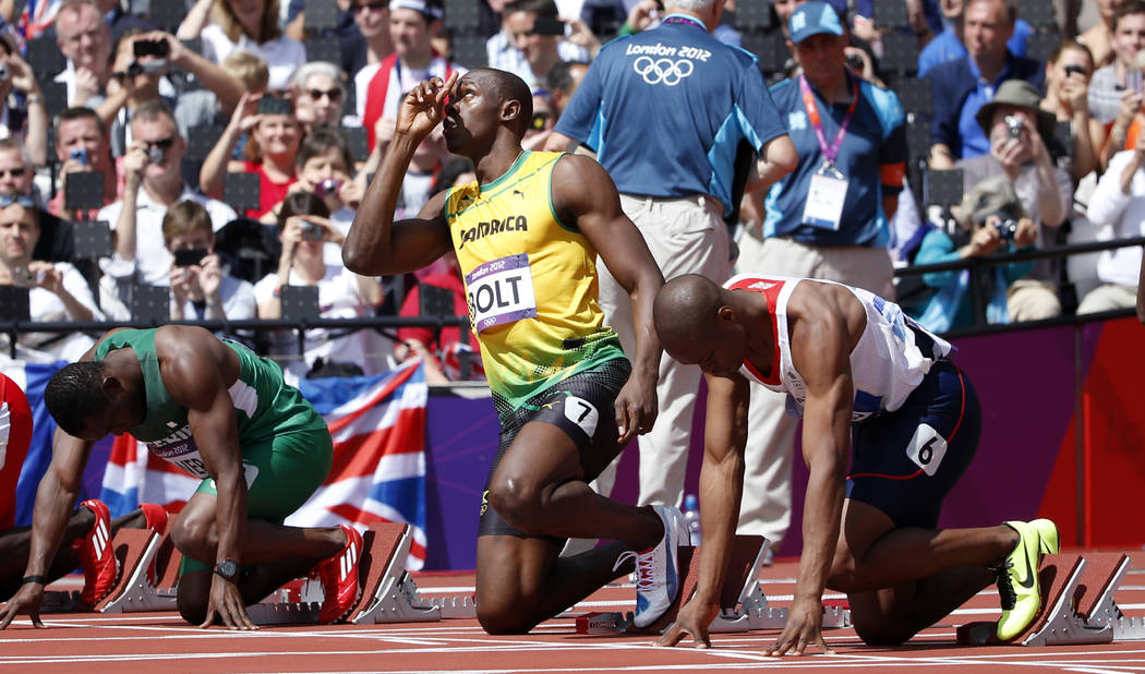 FILE - In this Aug. 4, 2012, file photo, Jamaica's Usain Bolt, center, gestures before competing in a men's 100-meter heat in the athletics competition at the Olympic Stadium during the 2012 Summe ...