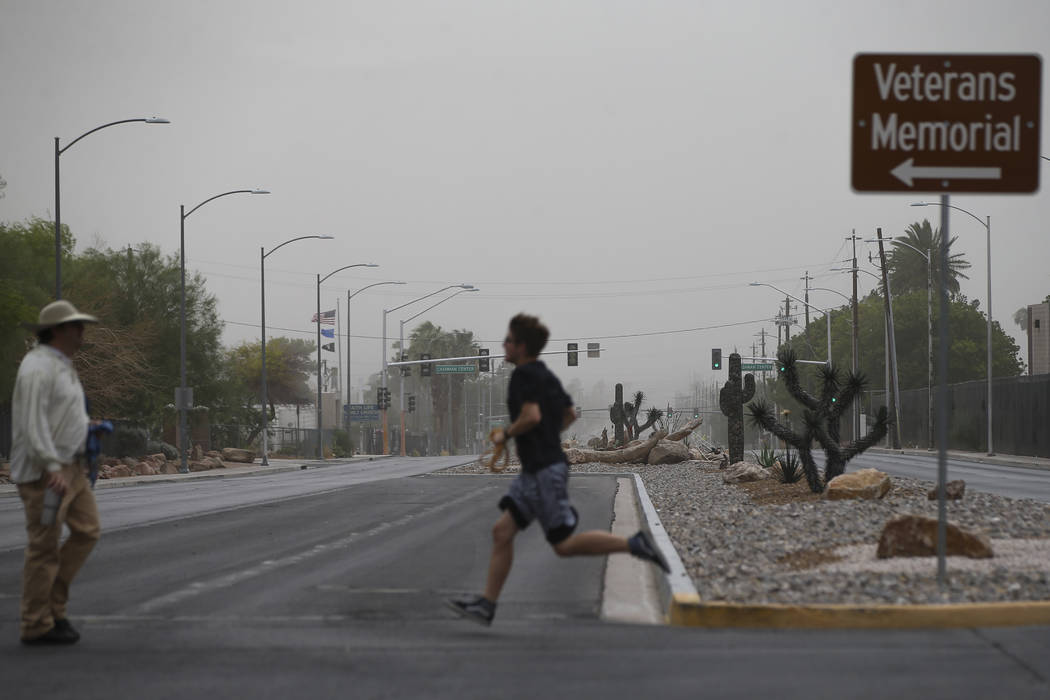 Dust fills the sky as people cross Washington Avenue near the Old Las Vegas Mormon Fort State Historical Park in Las Vegas on Saturday, July 21, 2018. Chase Stevens Las Vegas Review-Journal @csste ...