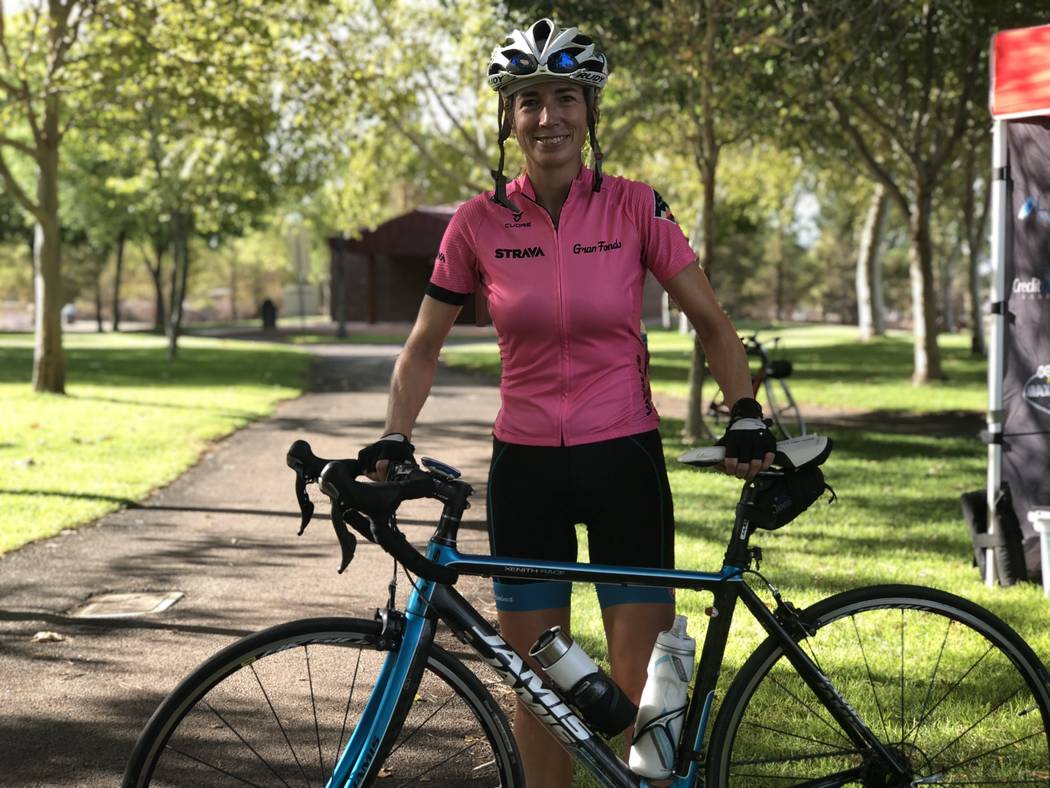 Joann Pavlovcak, 46, poses with her bike after completing a 25-mile ride on the newly-paved Interstate 11. The Southern Nevada Bicycle Coalition hosted the unique ride, offering cyclists a one-tim ...