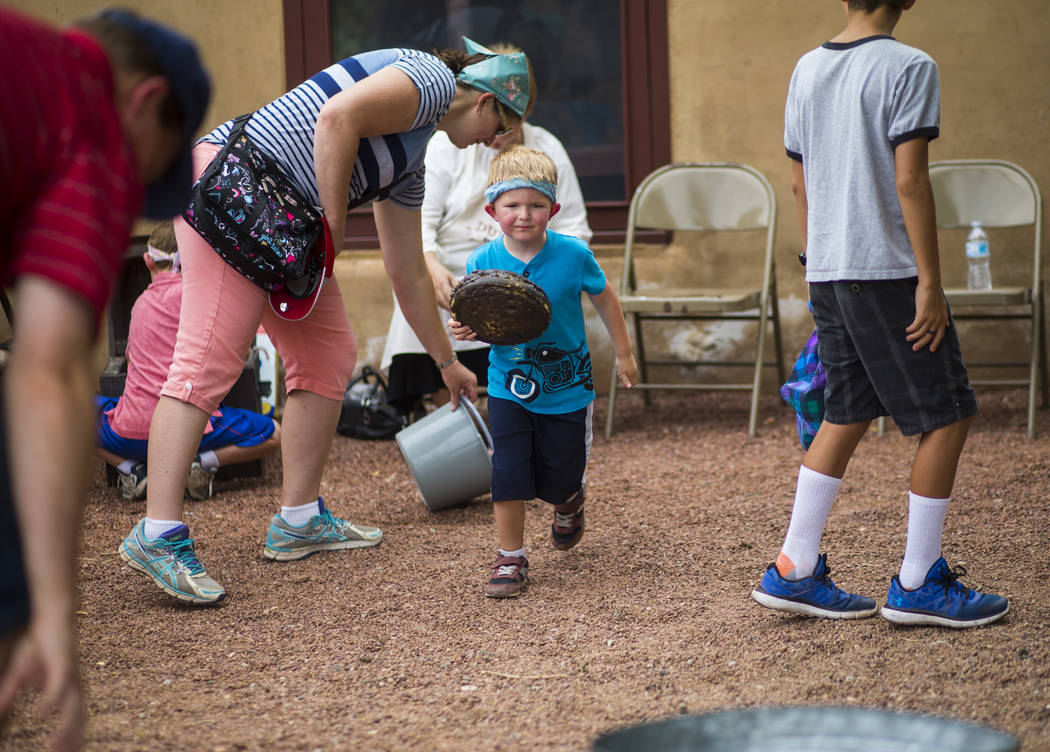 Four-year-old David competes in the buffalo chip toss during the "Pioneer Day" event at the Old Las Vegas Mormon Fort State Historical Park in Las Vegas on Saturday, July 21, 2018. Chase ...