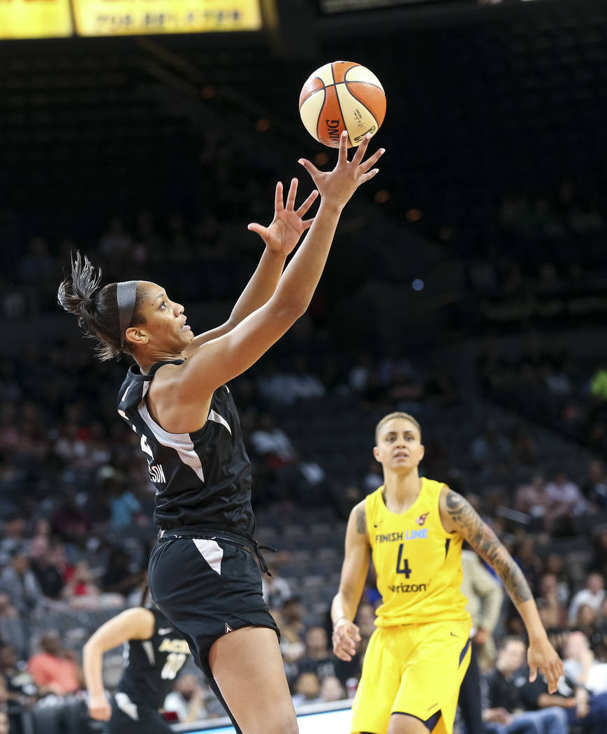 Las Vegas Aces center A'ja Wilson (22) pulls in the rebound as Indiana Fever forward Candice Dupree (4) heads down court during the first half of a WNBA basketball game at the Mandalay Bay Events ...