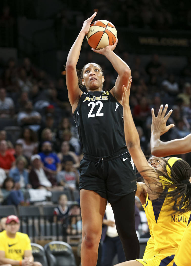 Las Vegas Aces center A'ja Wilson (22) shoots against Indiana Fever defenders during the second half of a WNBA basketball game at the Mandalay Bay Events Center in Las Vegas on Sunday, July 22, 20 ...