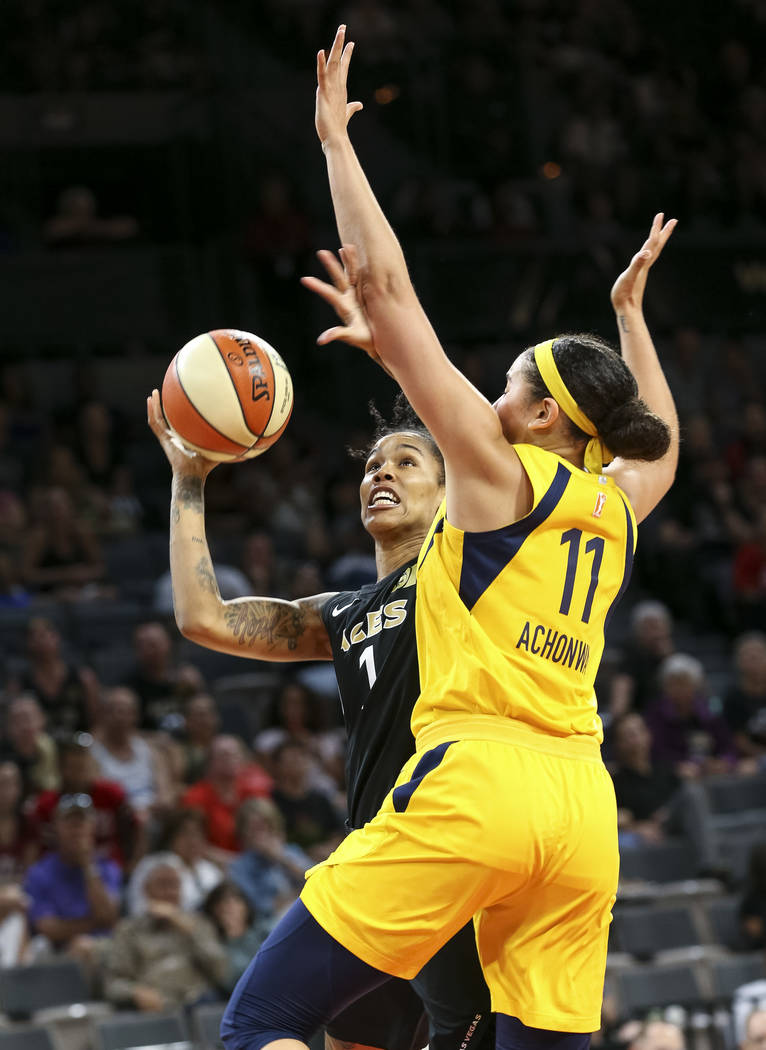 Las Vegas Aces forward Tamera Young (1) attempts a shot against Indiana Fever forward Natalie Achonwa (11) during the second half of a WNBA basketball game at the Mandalay Bay Events Center in Las ...