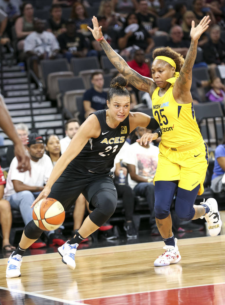 Las Vegas Aces guard Kayla McBride (21) drives the ball against Indiana Fever guard Cappie Pondexter (25) during the first half of a WNBA basketball game at the Mandalay Bay Events Center in Las V ...