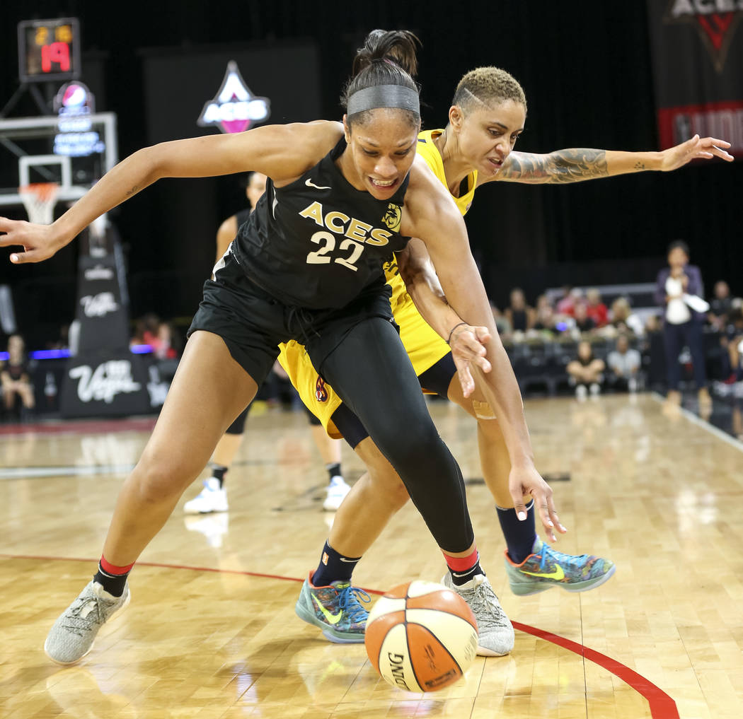 Las Vegas Aces center A'ja Wilson (22) and Indiana Fever forward Candice Dupree (4) battle for the ball during the first half of a WNBA basketball game at the Mandalay Bay Events Center in Las Veg ...