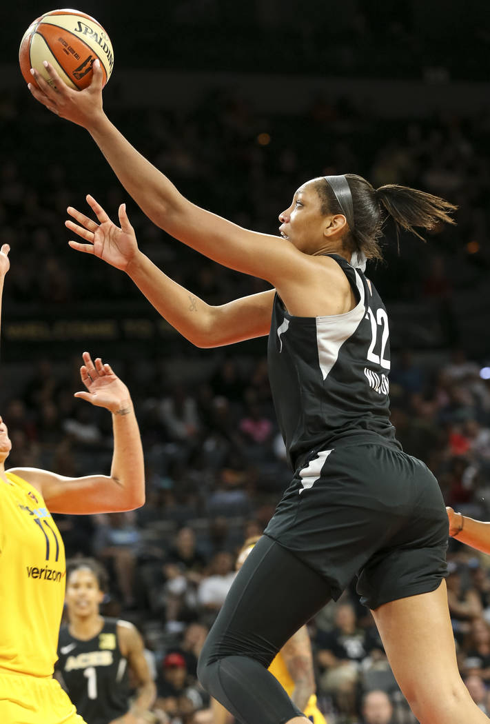 Las Vegas Aces center A'ja Wilson (22) goes up for a shot over Indiana Fever forward Natalie Achonwa (11) during the second half of a WNBA basketball game at the Mandalay Bay Events Center in Las ...