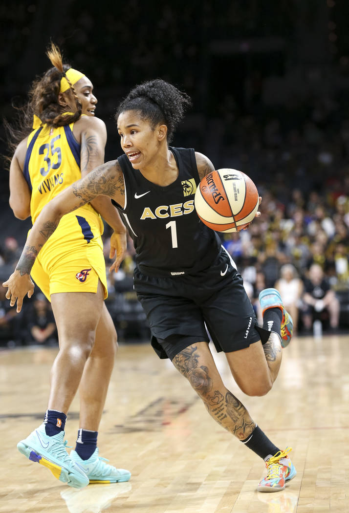 Las Vegas Aces forward Tamera Young (1) drives the ball past Indiana Fever guard Victoria Vivians (35) during the second half of a WNBA basketball game at the Mandalay Bay Events Center in Las Veg ...