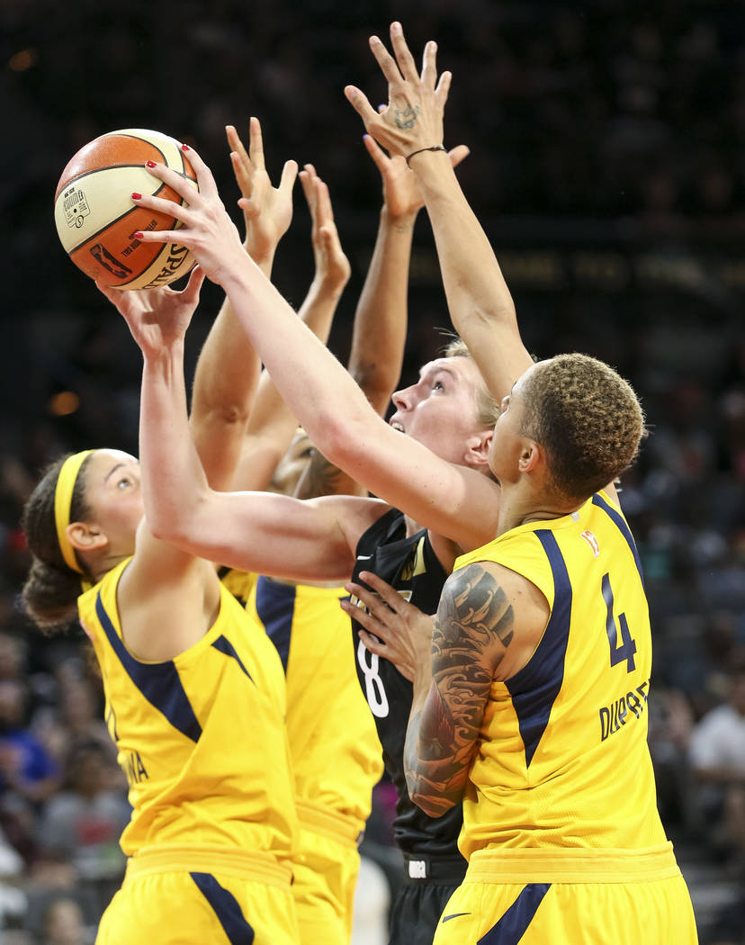 Las Vegas Aces center Carolyn Swords (8) goes up for a shot as she is swarmed by Indiana Fever defenders during the second half of a WNBA basketball game at the Mandalay Bay Events Center in Las V ...